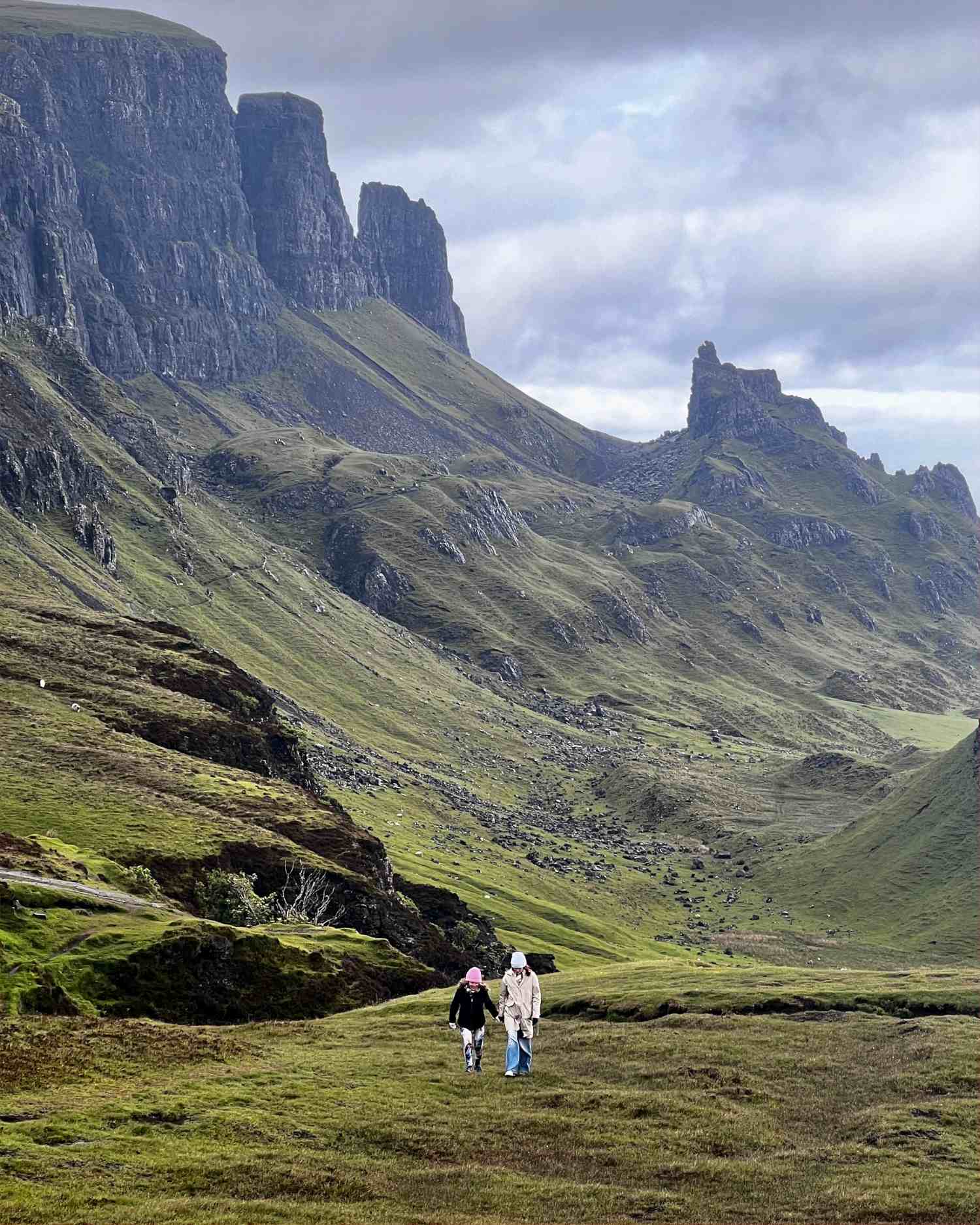 two guests walking through Quiraing landscape Isle of Skye